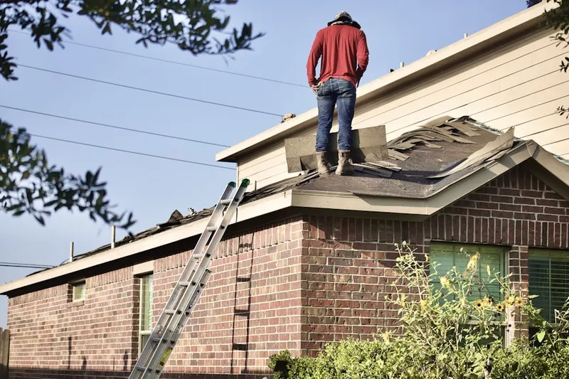 Professional roofer working on a residential roof in North Port Byron